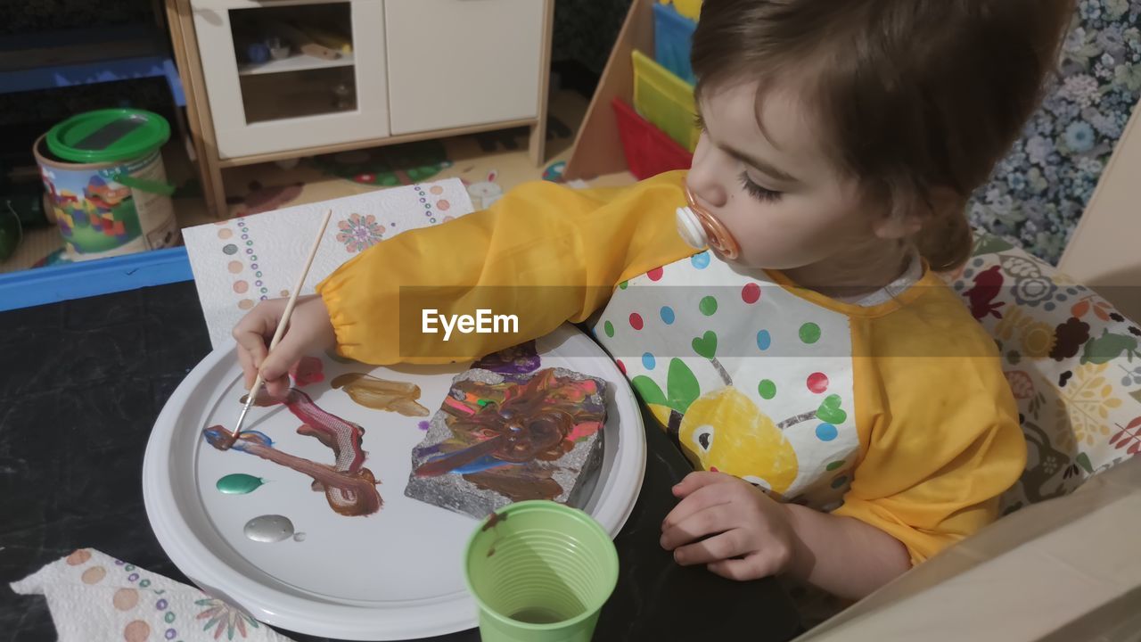 High angle view of girl on table at home