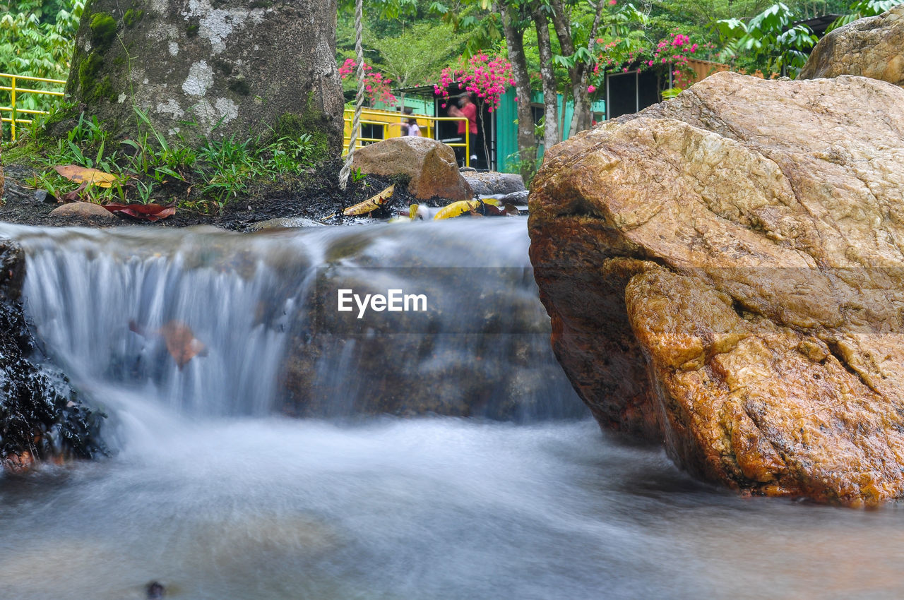 waterfall, water, body of water, beauty in nature, rock, plant, scenics - nature, nature, motion, water feature, tree, watercourse, long exposure, stream, river, flowing water, environment, autumn, forest, flowing, water resources, land, outdoors, rapid, blurred motion, no people, travel destinations, day, rock formation, non-urban scene, travel, tourism