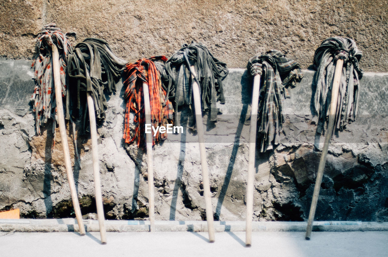 Various mops against wall