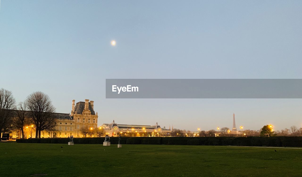 Scenic view of illuminated city against clear sky at night