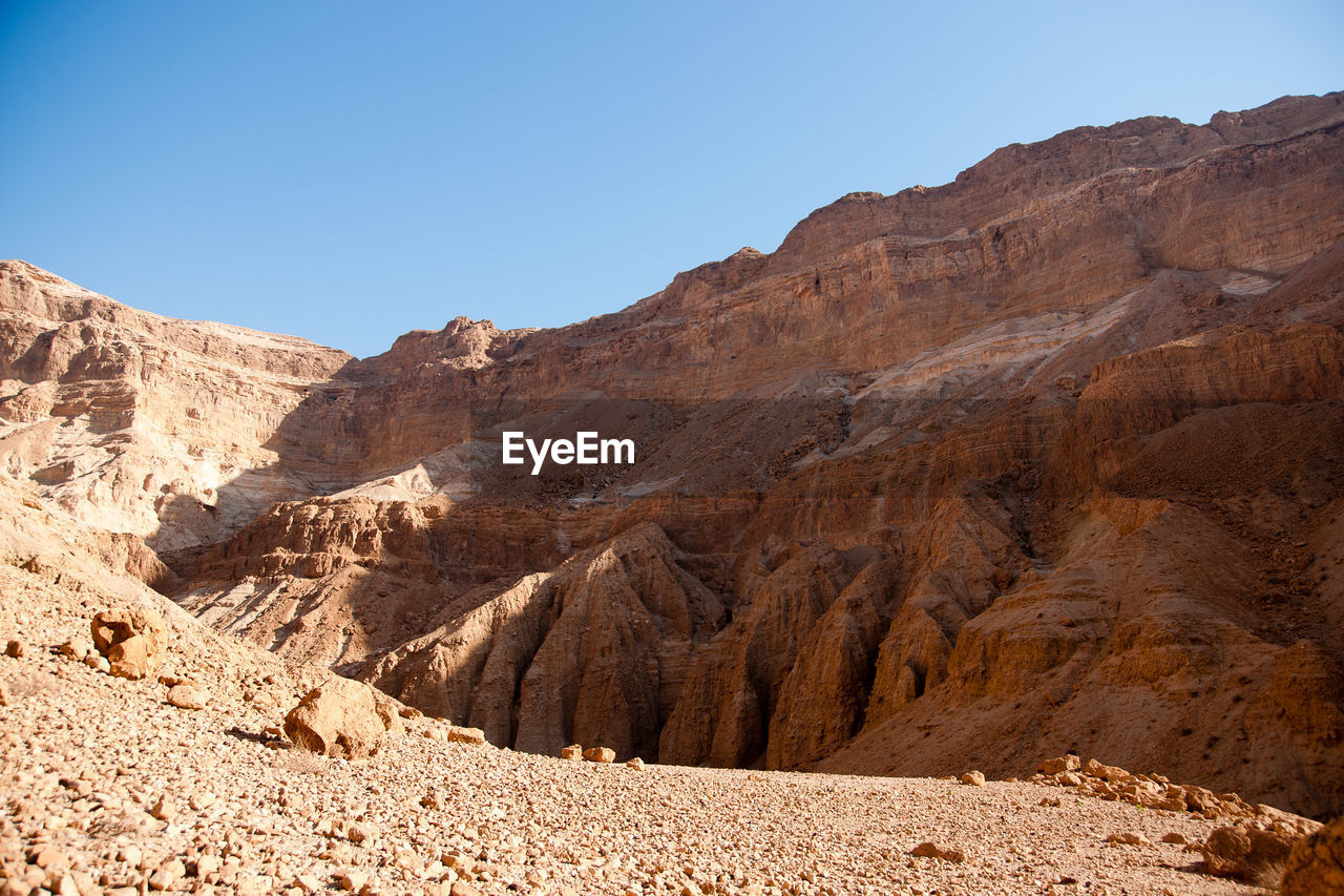 ROCK FORMATIONS ON MOUNTAIN AGAINST CLEAR SKY