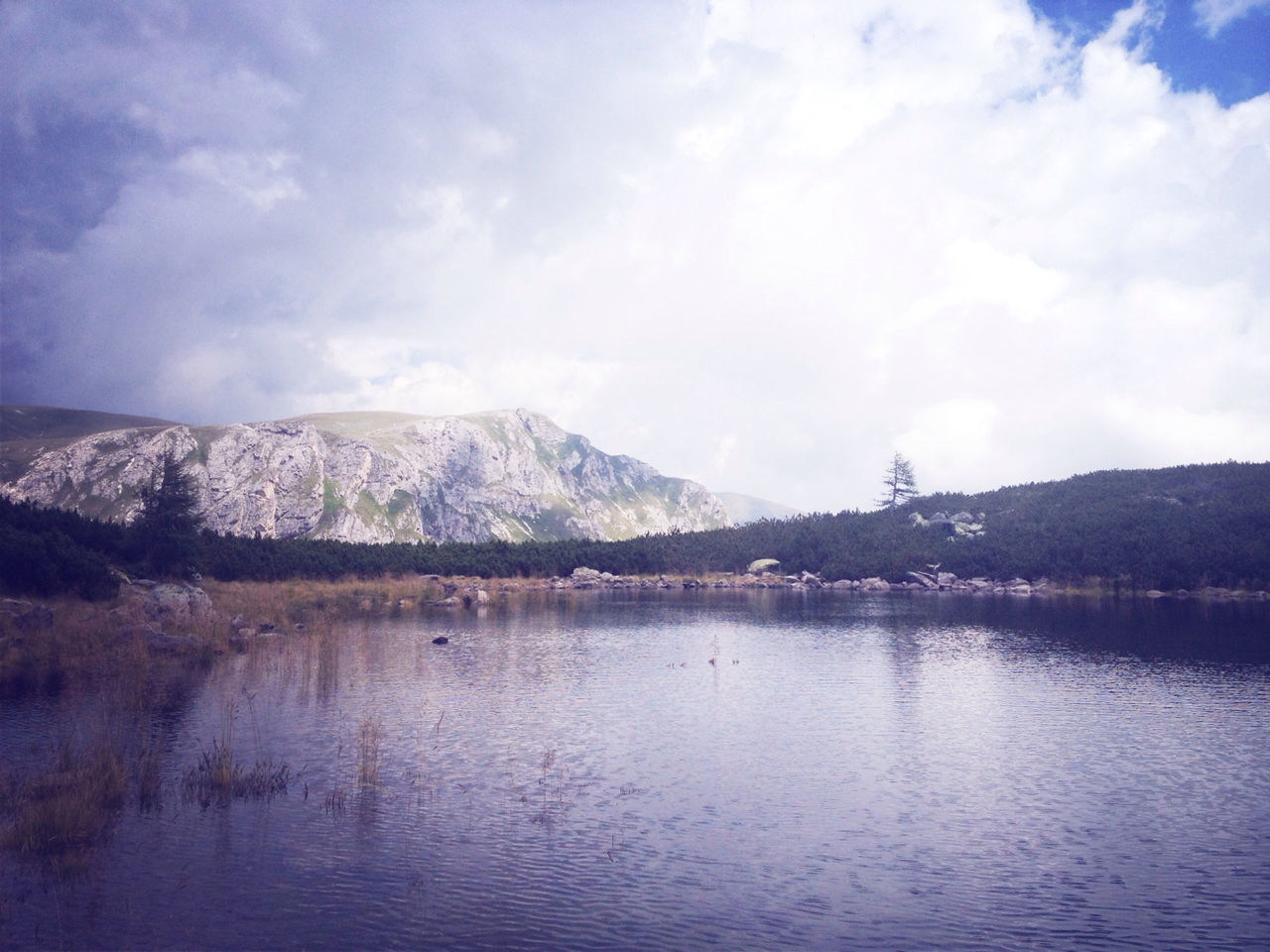 SCENIC VIEW OF MOUNTAINS AGAINST CLOUDY SKY