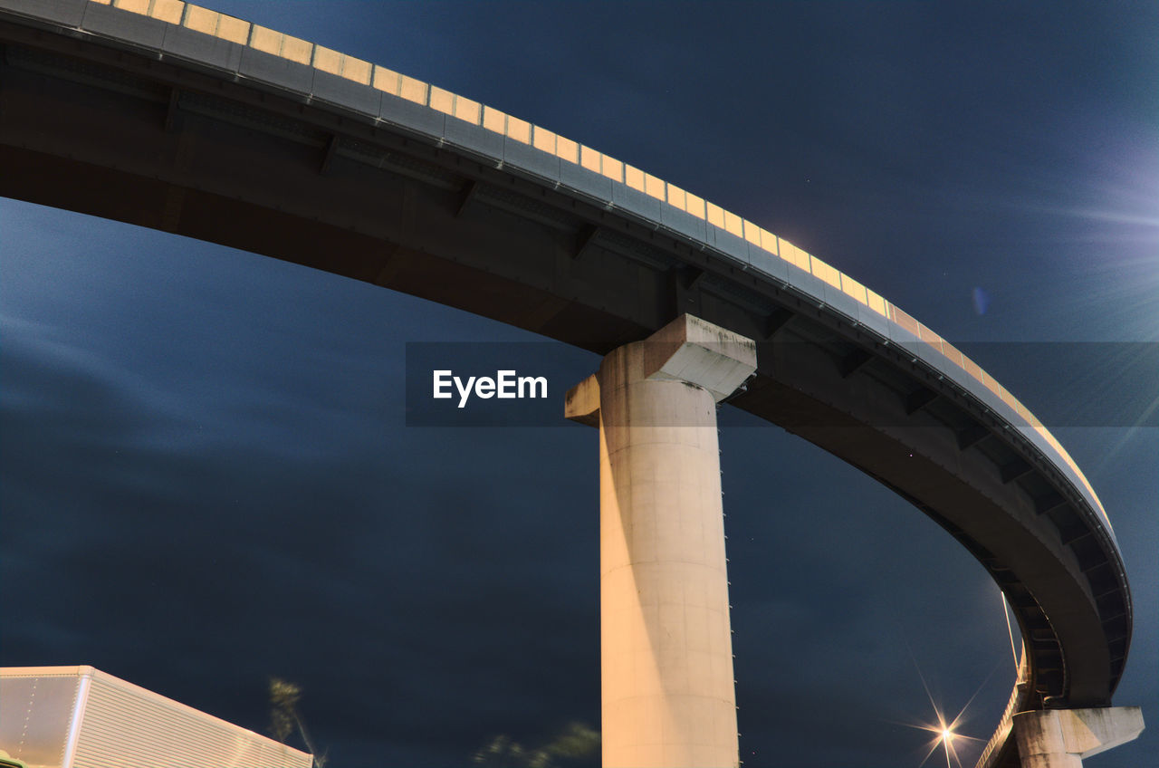 architecture, bridge, built structure, landmark, transportation, overpass, sky, arch, night, nature, illuminated, city, low angle view, no people, outdoors, water, reflection, building exterior, long exposure, dusk, road, travel destinations