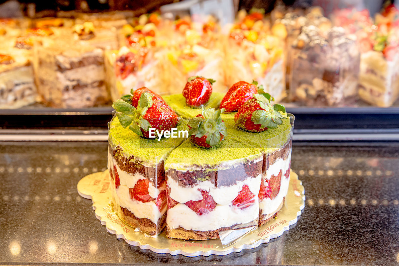 food and drink, food, sweet food, dessert, sweet, freshness, cake, fruit, baked, sweetness, birthday cake, temptation, fruitcake, berry, indoors, store, healthy eating, strawberry, still life, no people, bakery, close-up, pâtisserie, focus on foreground, meal, pastry, cuisine, table