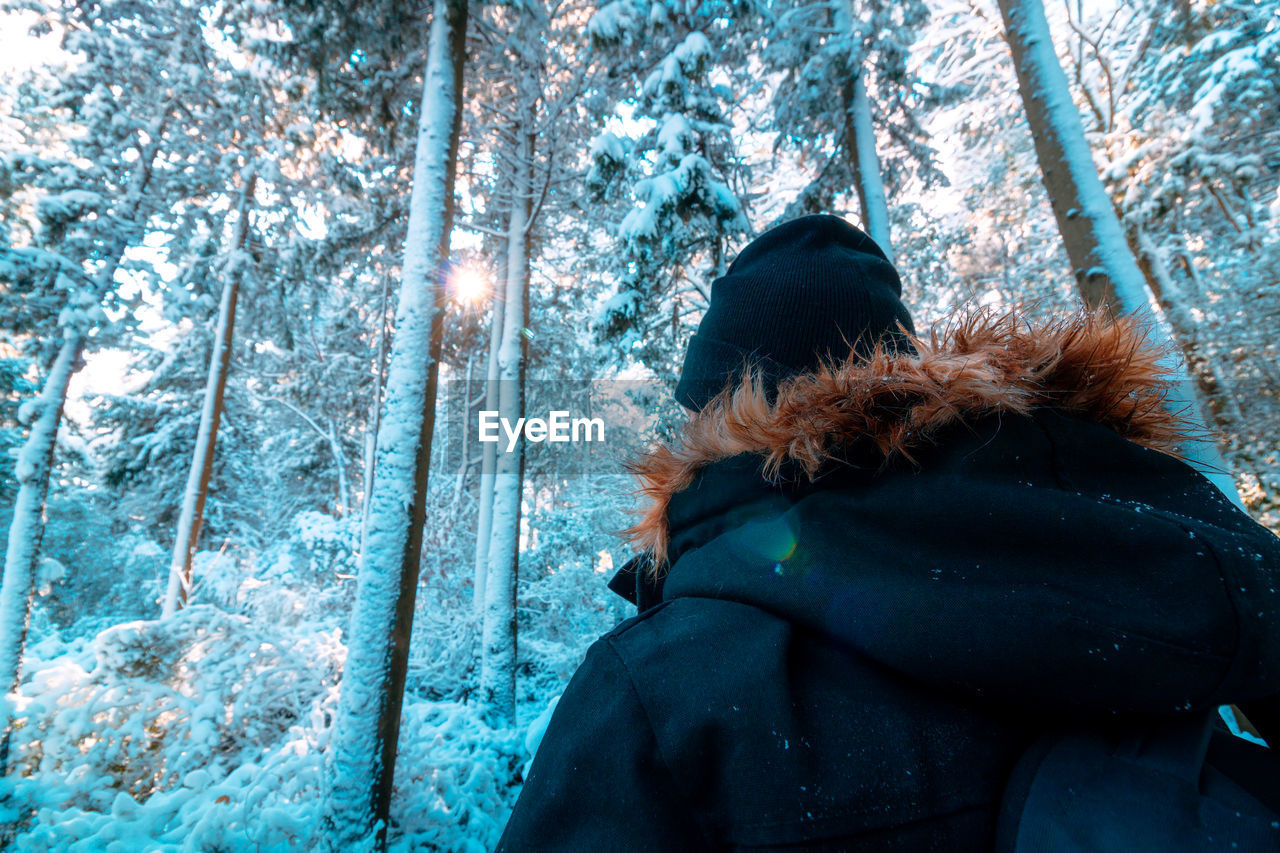 PORTRAIT OF PERSON IN SNOW COVERED LAND