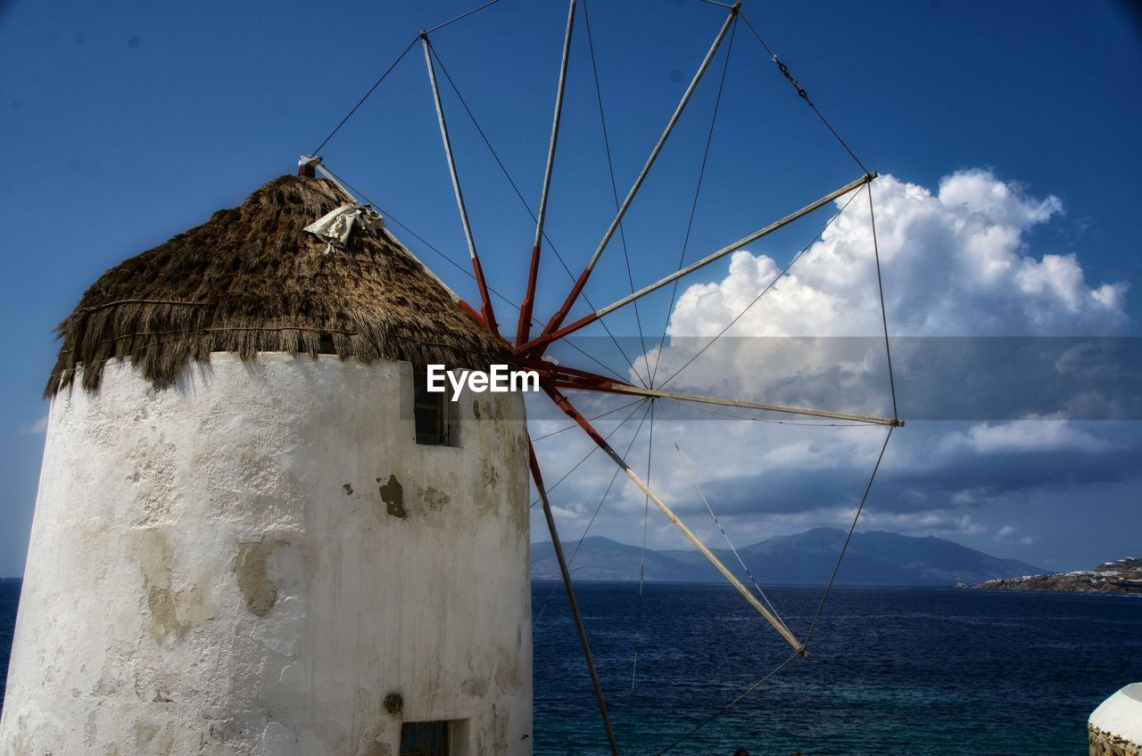 water, sea, windmill, sky, nature, architecture, nautical vessel, mill, wind power, blue, no people, wind, renewable energy, wind turbine, transportation, cloud, built structure, environment, alternative energy, turbine, sailboat, ship, day, outdoors, environmental conservation, travel, land, beach, scenics - nature, ocean, beauty in nature, power generation, travel destinations, traditional windmill, building exterior