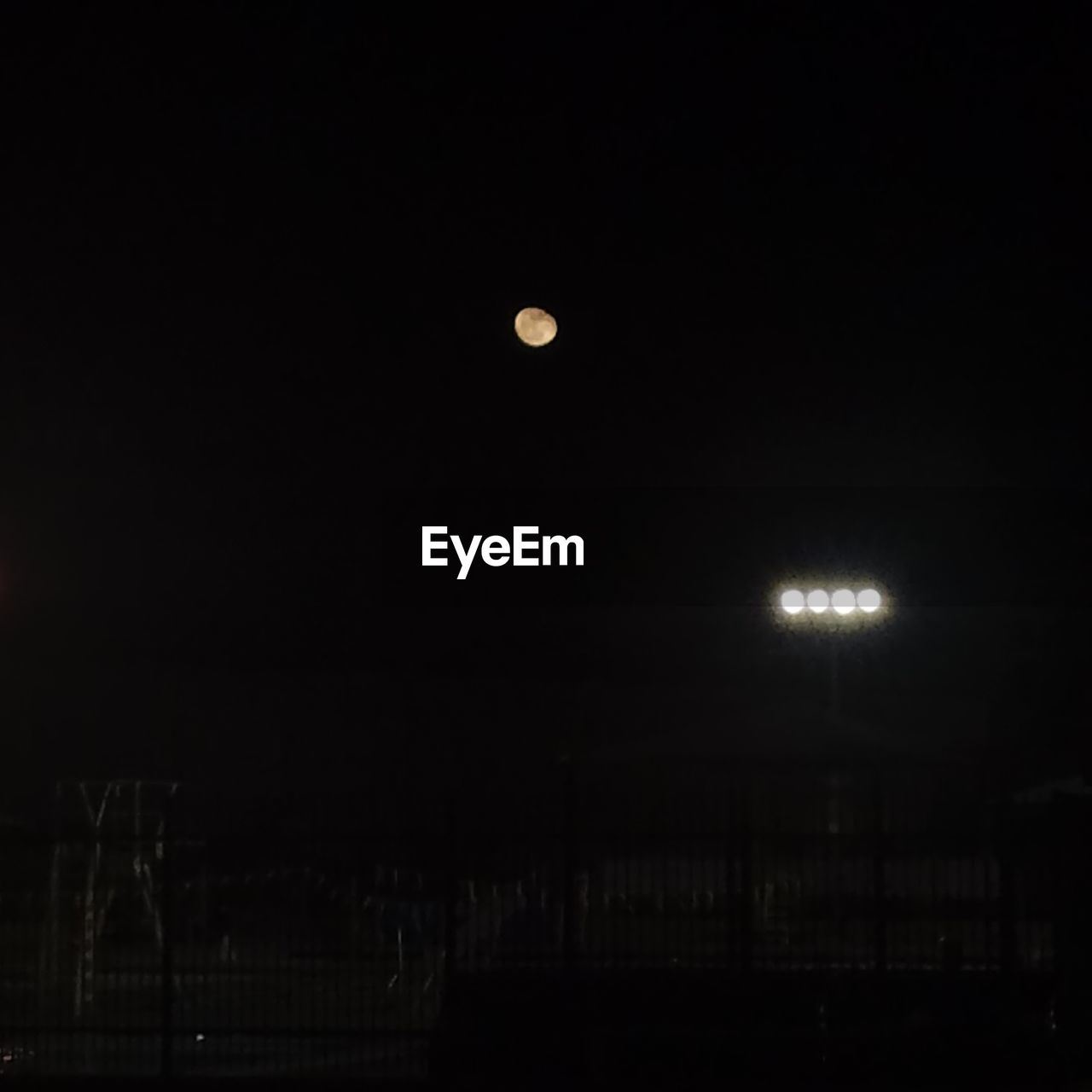 LOW ANGLE VIEW OF ILLUMINATED MOON IN SKY AT NIGHT