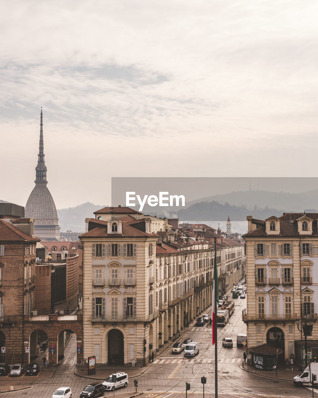 Buildings in city against cloudy sky