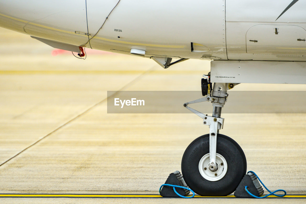 Close-up of airplane at airport runway