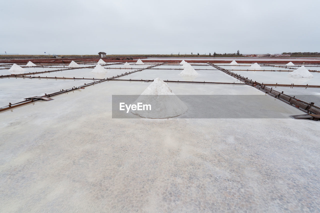 Jingzaijiao tile paved salt fields with dry salt ready for harvesting in cloudy weather in tainan city in taiwan