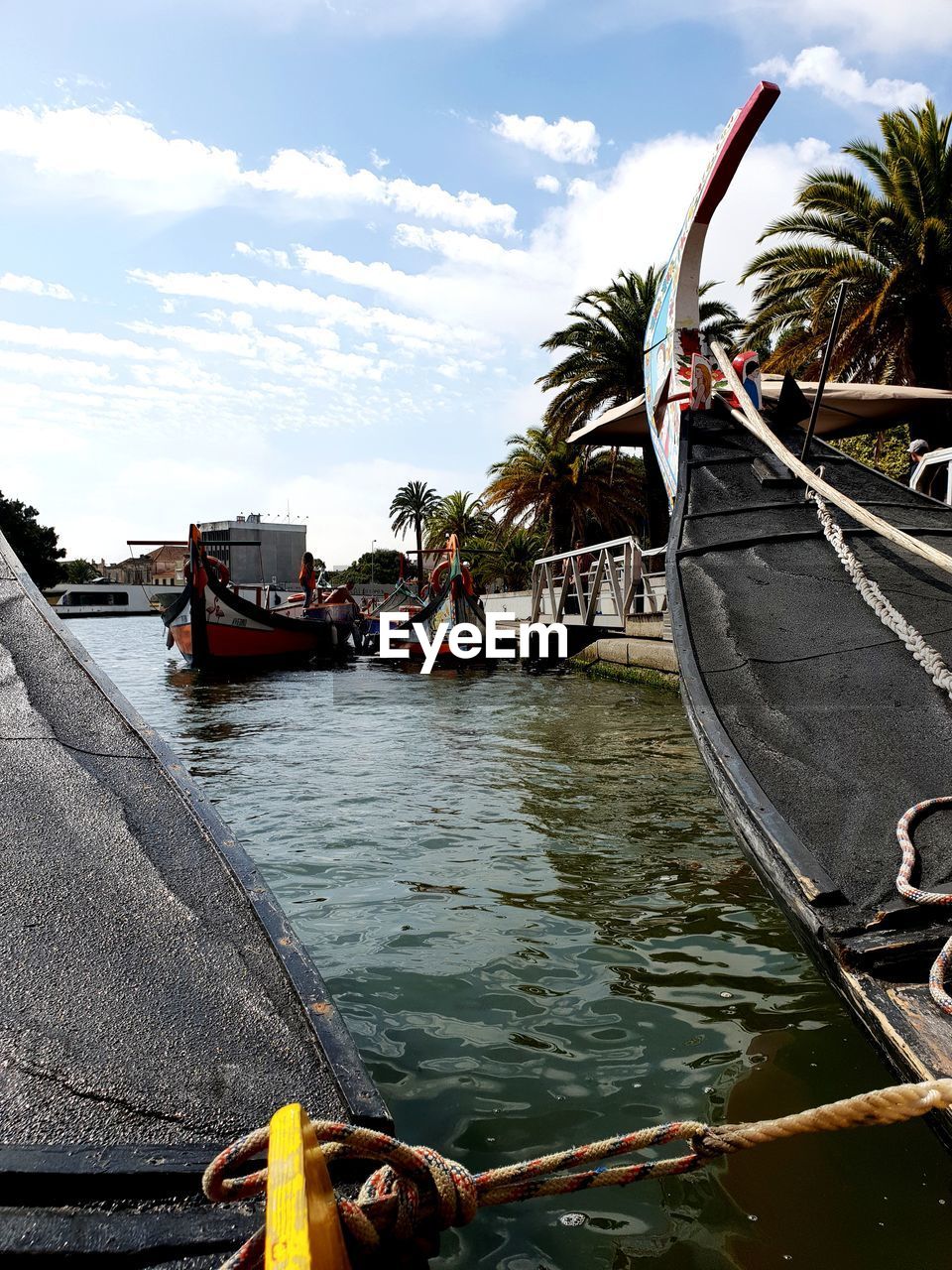 FISHING BOAT MOORED AT SEA SHORE AGAINST SKY