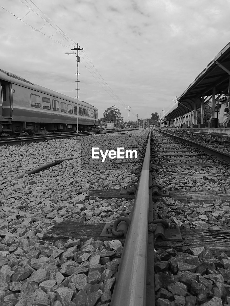 RAILROAD TRACK BY BRIDGE AGAINST SKY