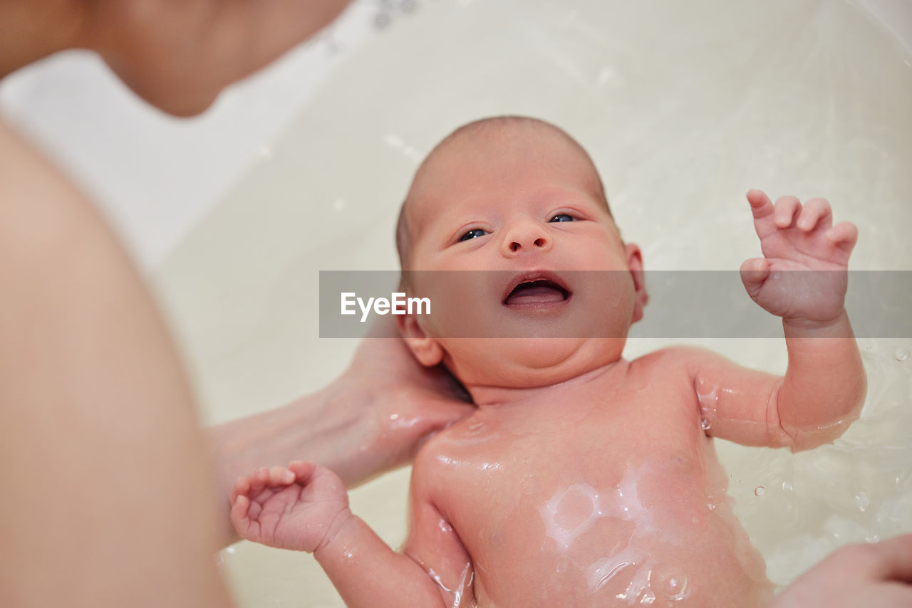 Cute baby taking bath in bathtub