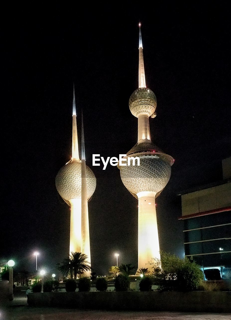 Low angle view of illuminated tower at night