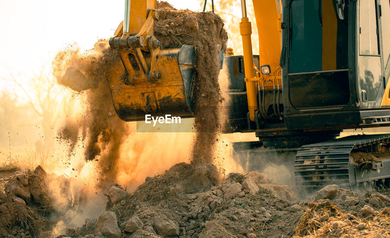 Close-up of excavator at construction site. backhoe digging soil for earthwork and construction