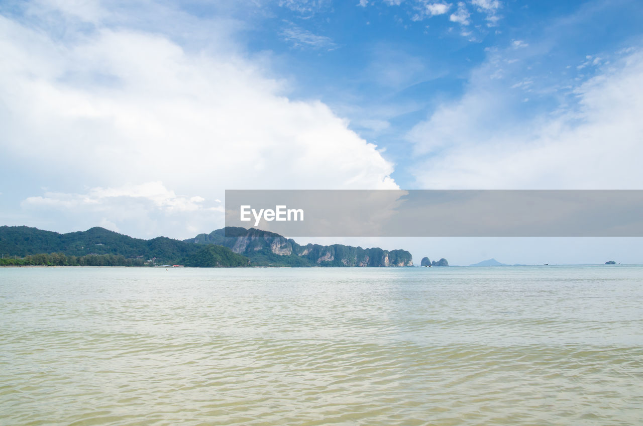 Scenic view of sea and mountains against sky