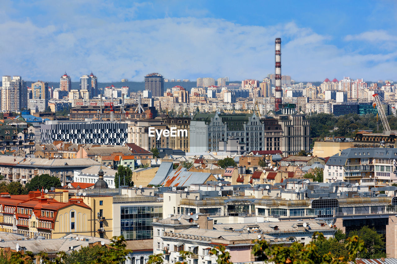 The landscape of summer kyiv with a view of the old district of podil with dense development.