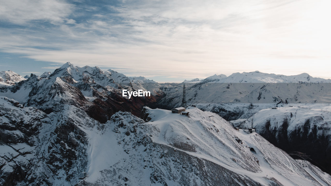 Scenic view of snow covered mountains against sky