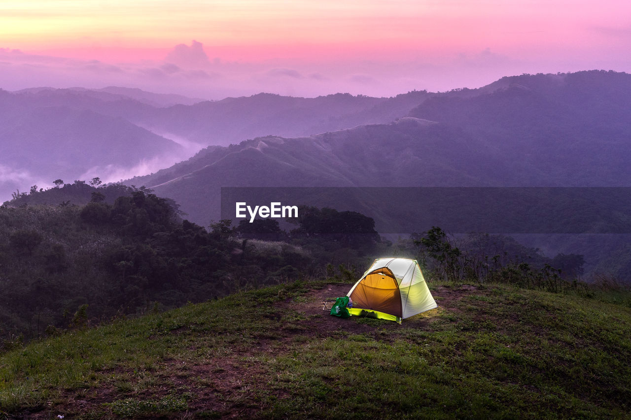 High angle view of tent on mountains against sky during sunset