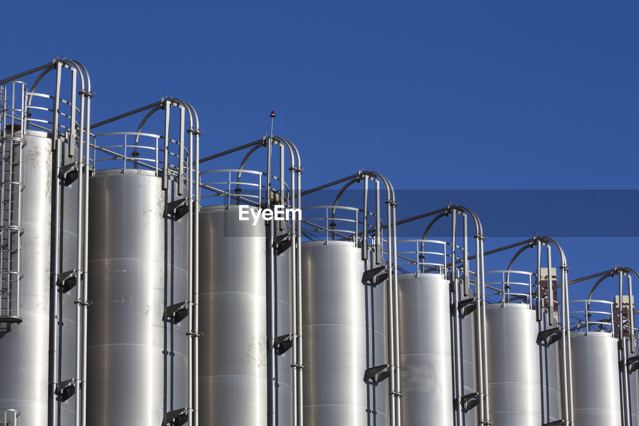 Low angle view of industry against clear sky