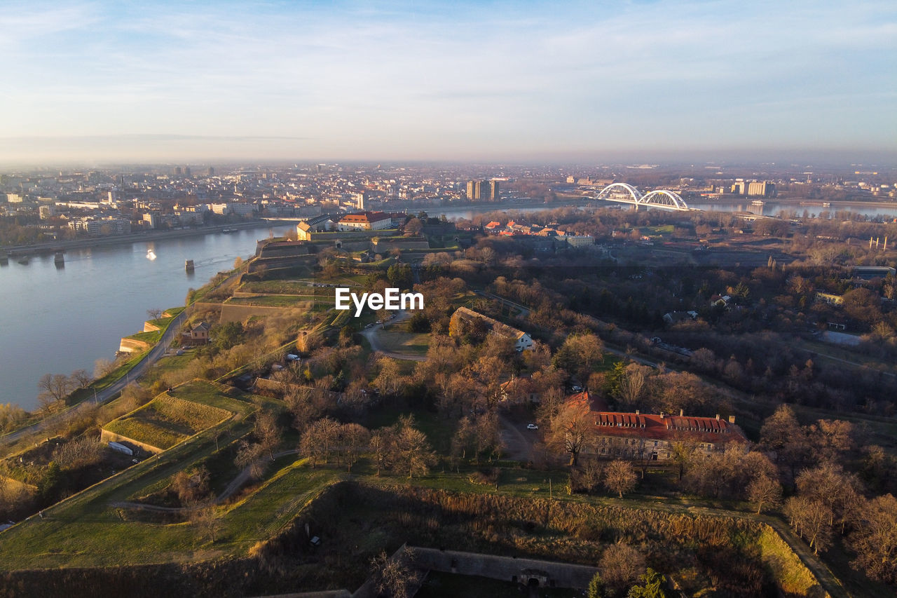 High angle view of river amidst buildings in city against sky