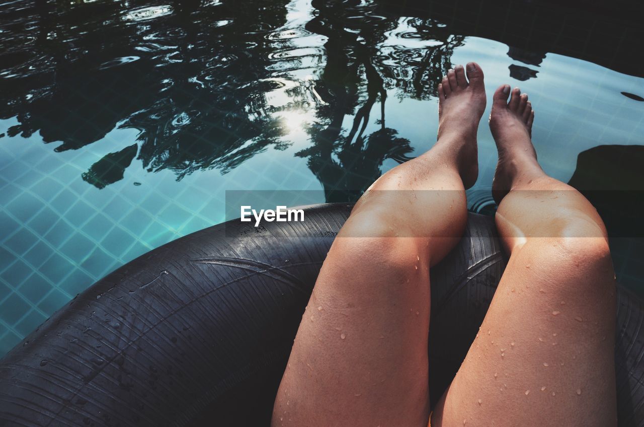 Woman's feet in swimming pool