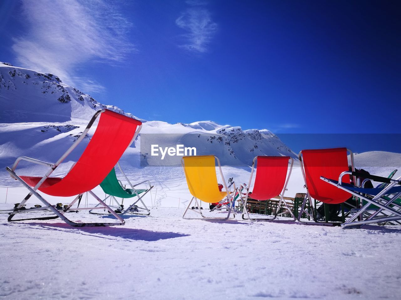 UMBRELLA ON SNOW COVERED FIELD AGAINST SKY