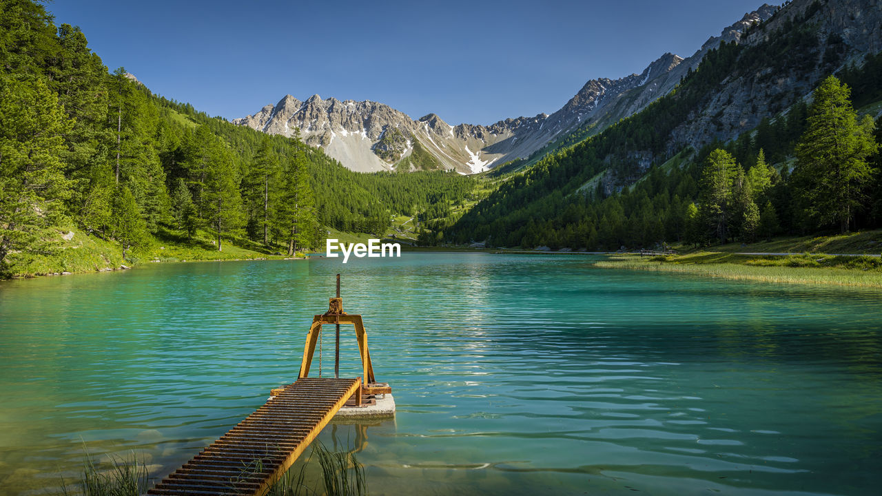 Scenic view of lake and mountains against sky