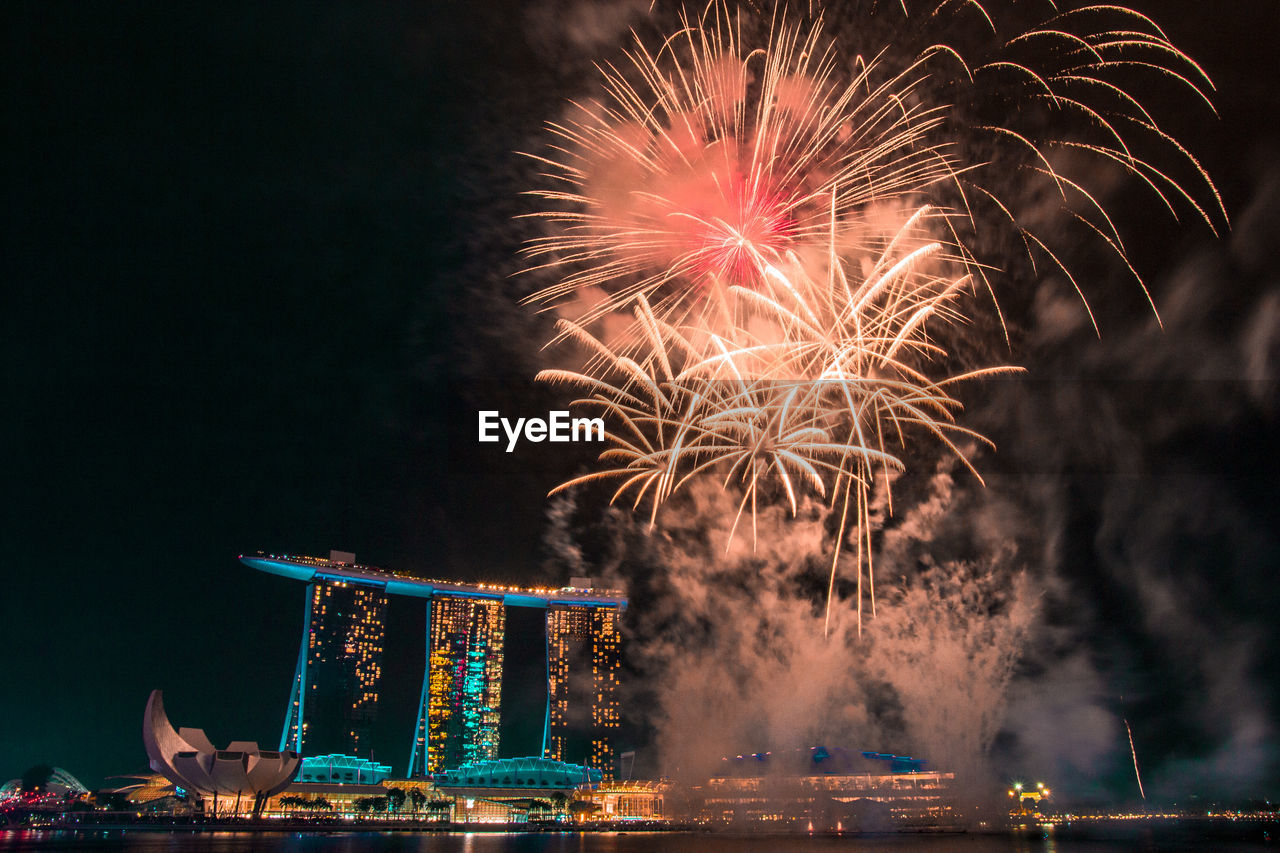 LOW ANGLE VIEW OF FIREWORK DISPLAY IN SKY AT NIGHT