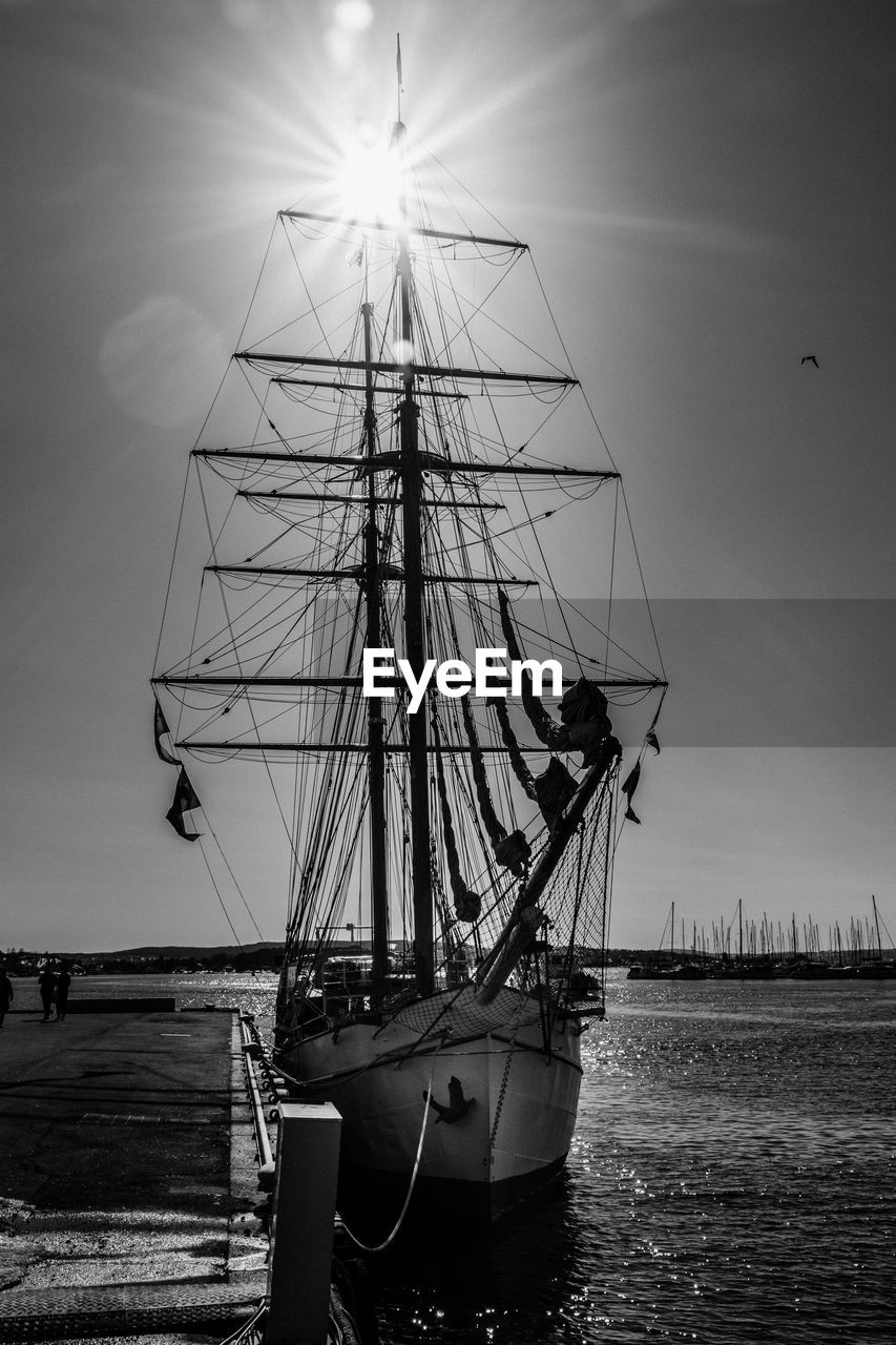SAILBOAT MOORED ON SEA AGAINST SKY