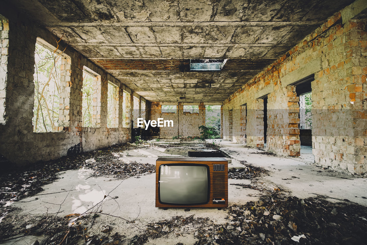 Old television set in abandoned house