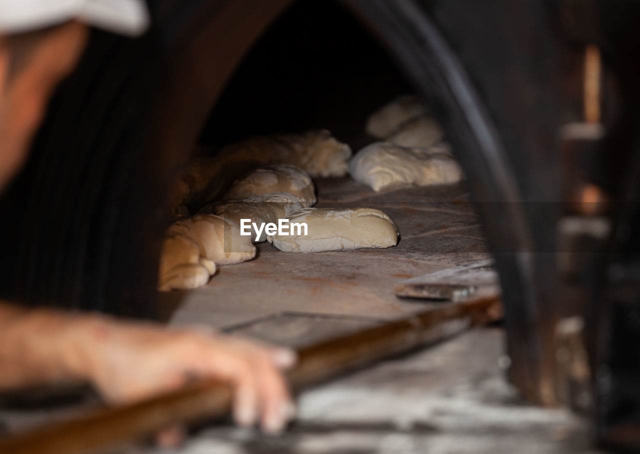 Close-up of man preparing bread in bakery