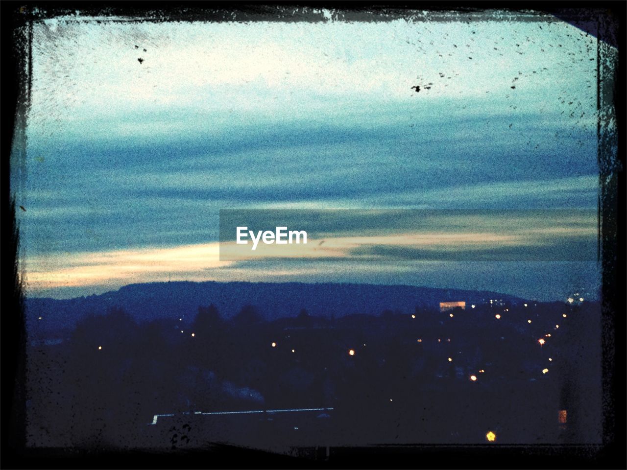 SCENIC VIEW OF MOUNTAINS AGAINST CLOUDY SKY