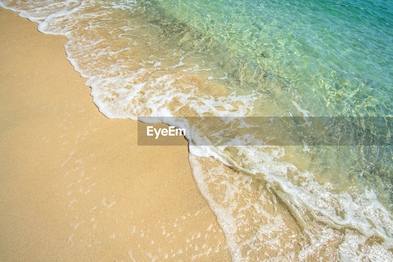 Soft wave of blue ocean on sandy beach. background.