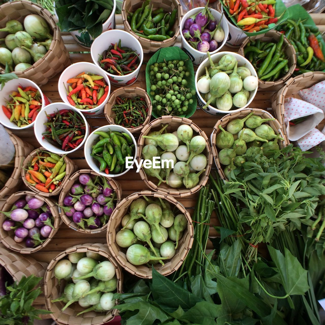 High angle view of various vegetables in containers arranged on table