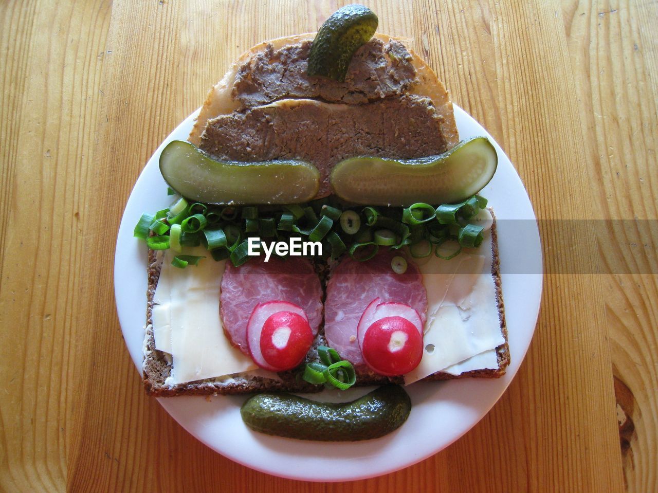 High angle view of anthropomorphic face made from bread and vegetables