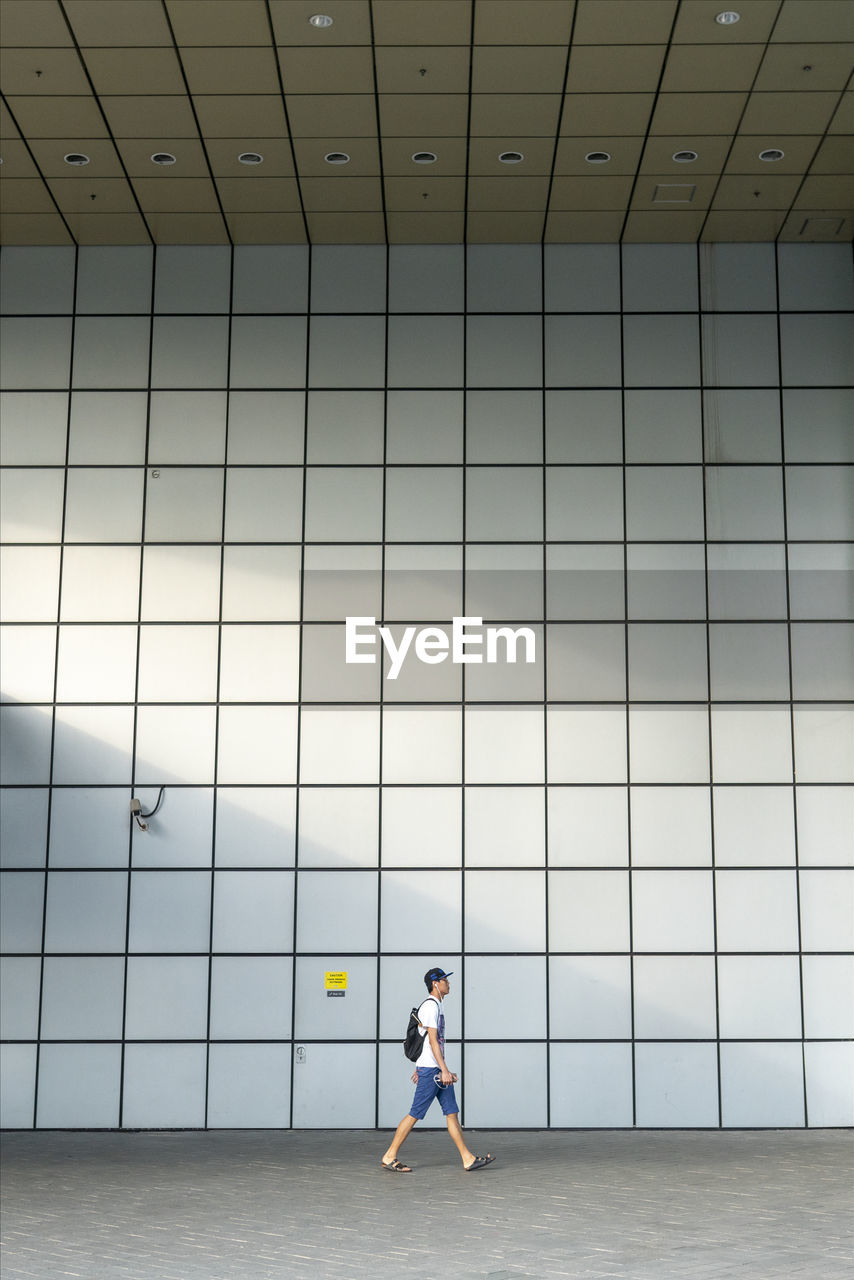 WOMAN STANDING ON WALL