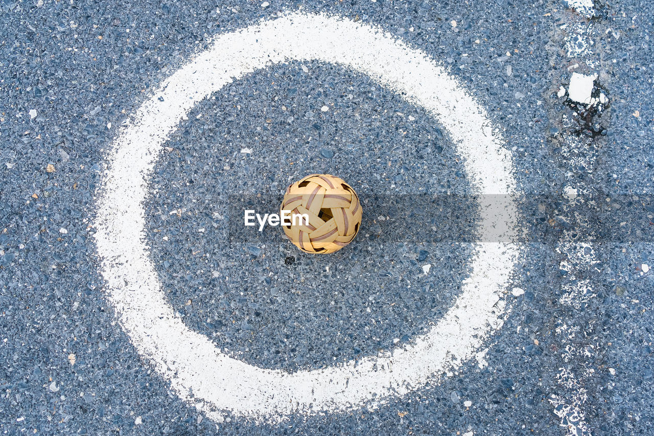 circle, road, high angle view, no people, asphalt, symbol, geometric shape, transportation, day, street, number, shape, city, sign, directly above, road surface, creativity, blue, outdoors, road marking, white, anthropomorphic smiley face