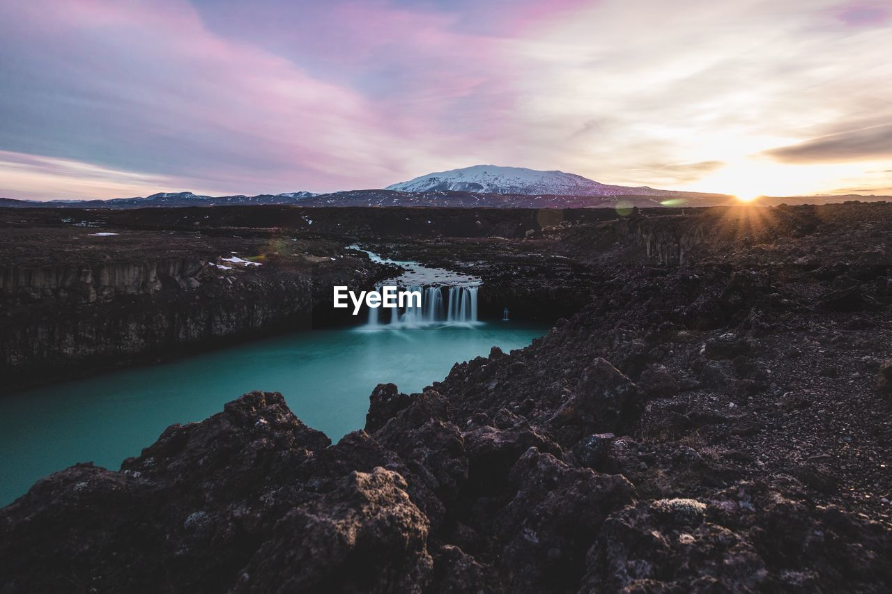 Scenic view of lake against sky during sunset