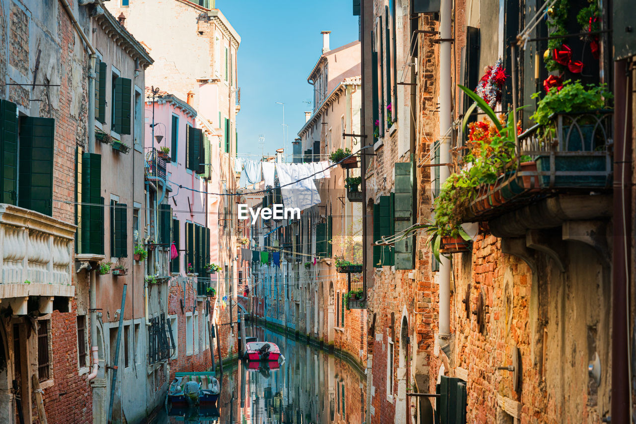 View of buildings by canal in city