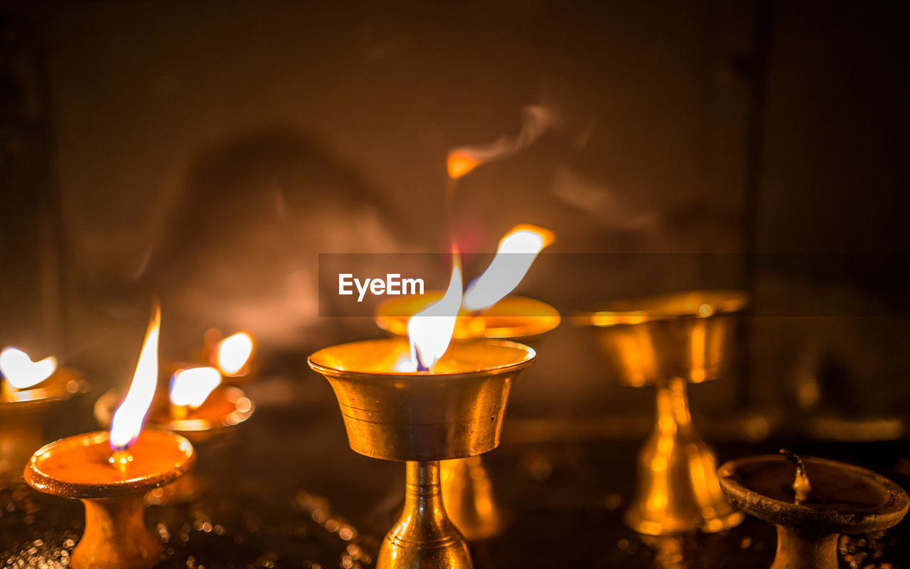 burning, fire, flame, heat, lighting, candle, yellow, nature, light, darkness, no people, illuminated, religion, food and drink, tradition, indoors, focus on foreground, close-up, night, lighting equipment, spirituality, ceremony, glowing, household equipment, celebration, food, belief