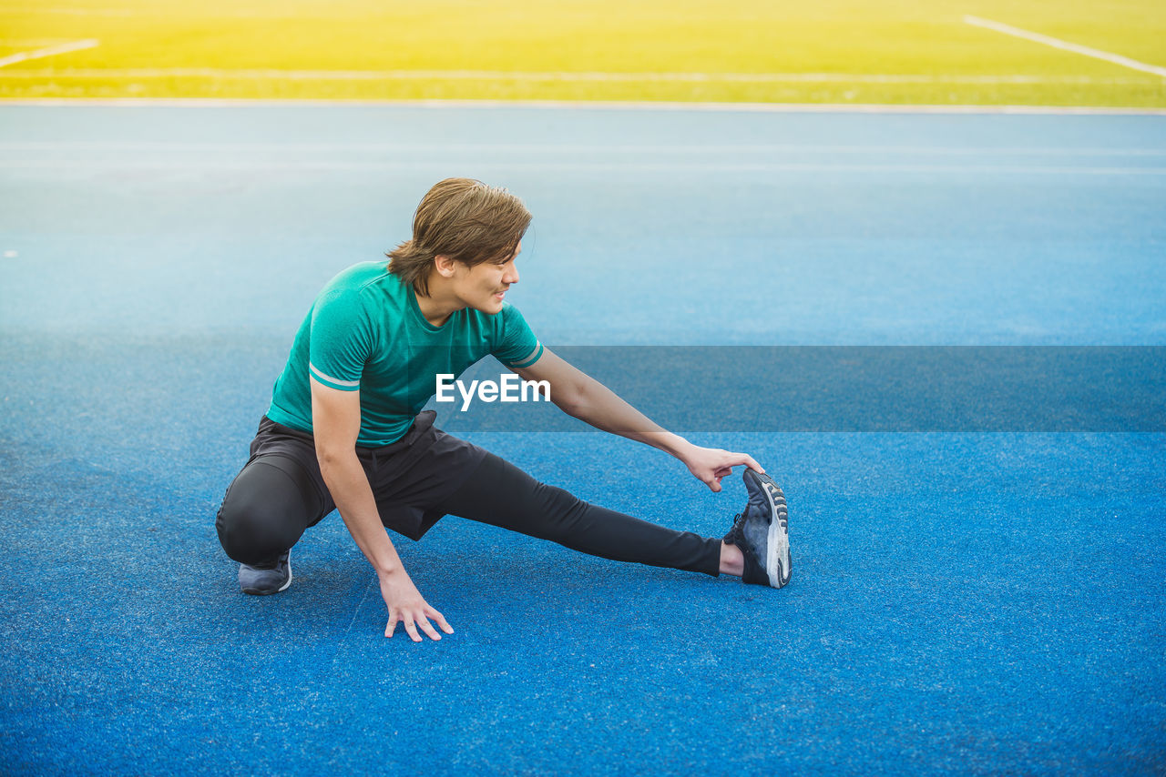 Young man exercising at stadium