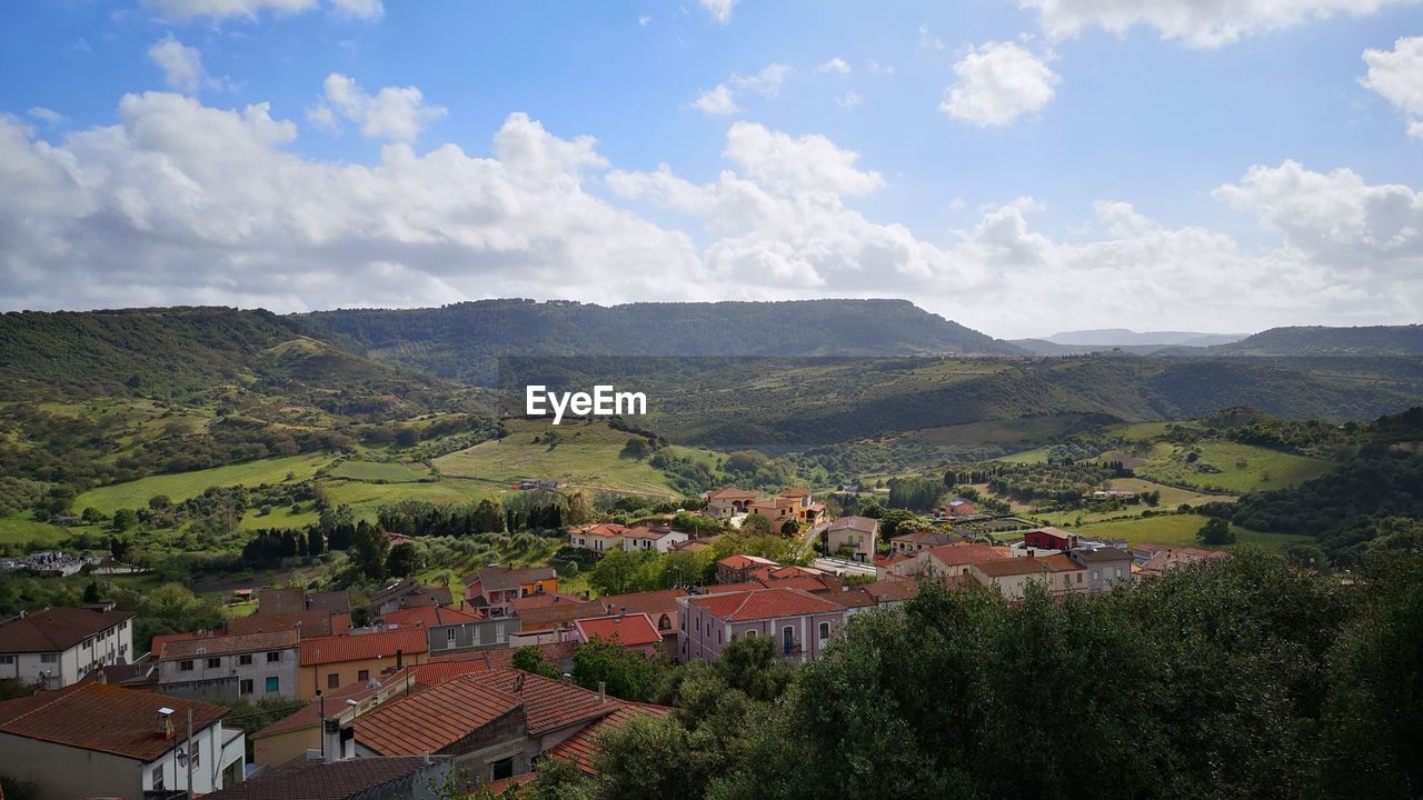 Aerial view of townscape against sky and mountainridge