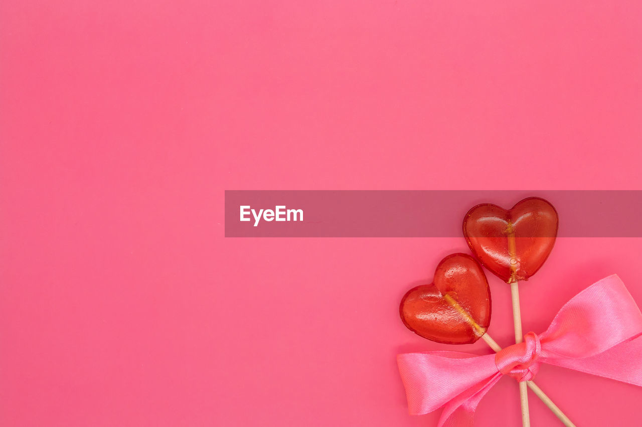 CLOSE-UP OF HEART SHAPE WITH PINK PETALS