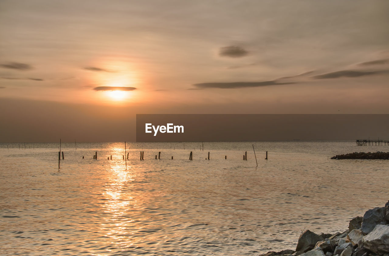 Scenic view of sea against sunset sky