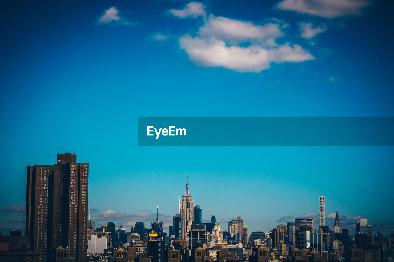 View of skyscrapers against blue sky