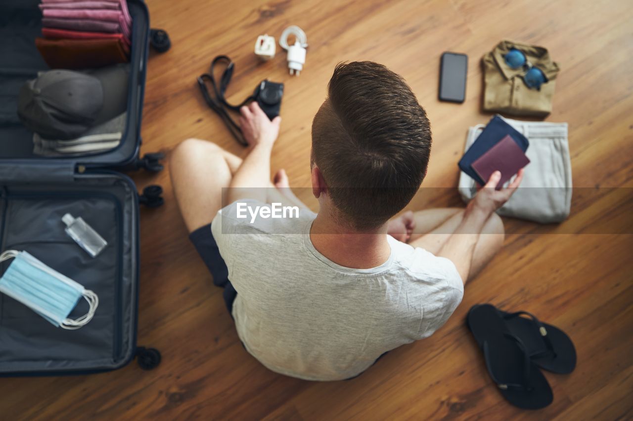 High angle view of man using mobile phone on table