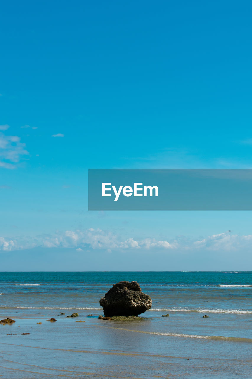 Scenic view of a rock and sea against sky