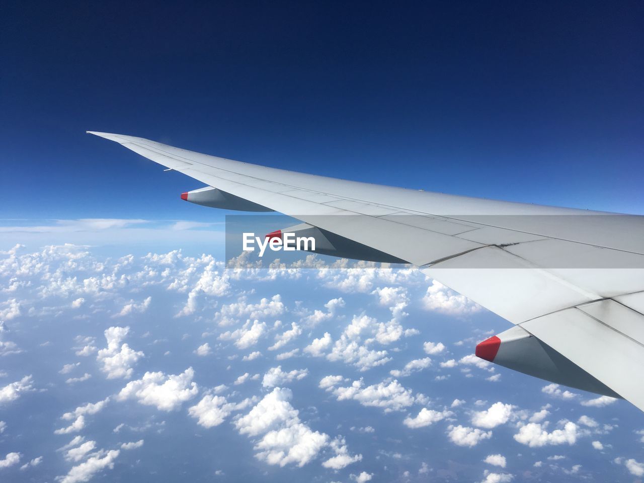 AIRPLANE WING AGAINST SKY