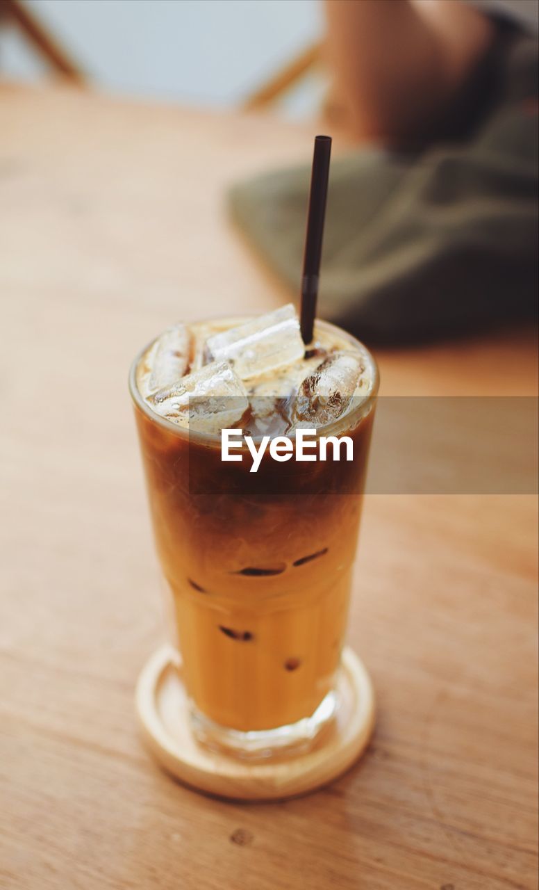 CLOSE-UP OF ICE CREAM IN GLASS ON TABLE